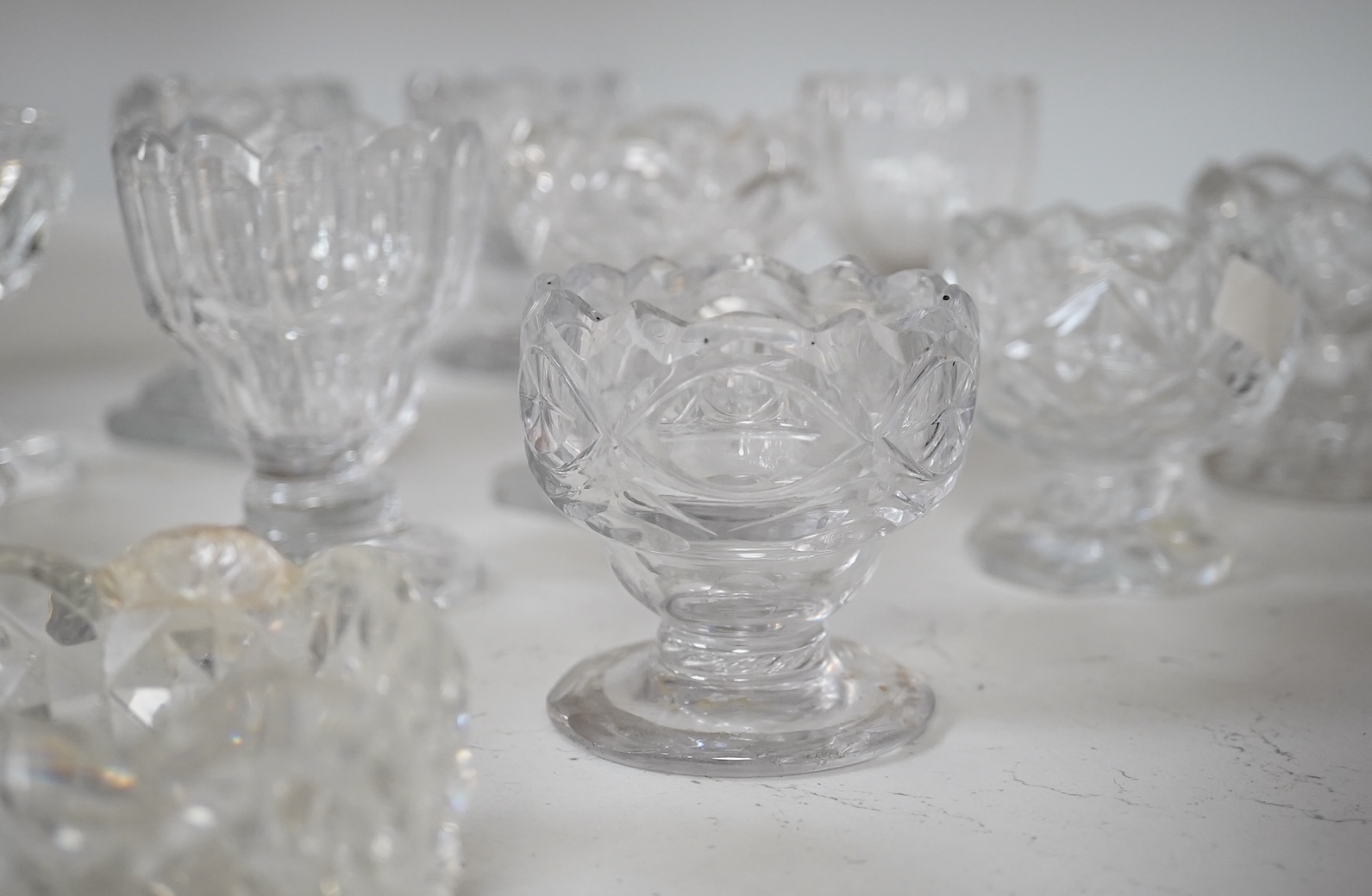 A group of twelve Georgian cut glass salts, tallest 9cm. Condition - fair to good, some chipping